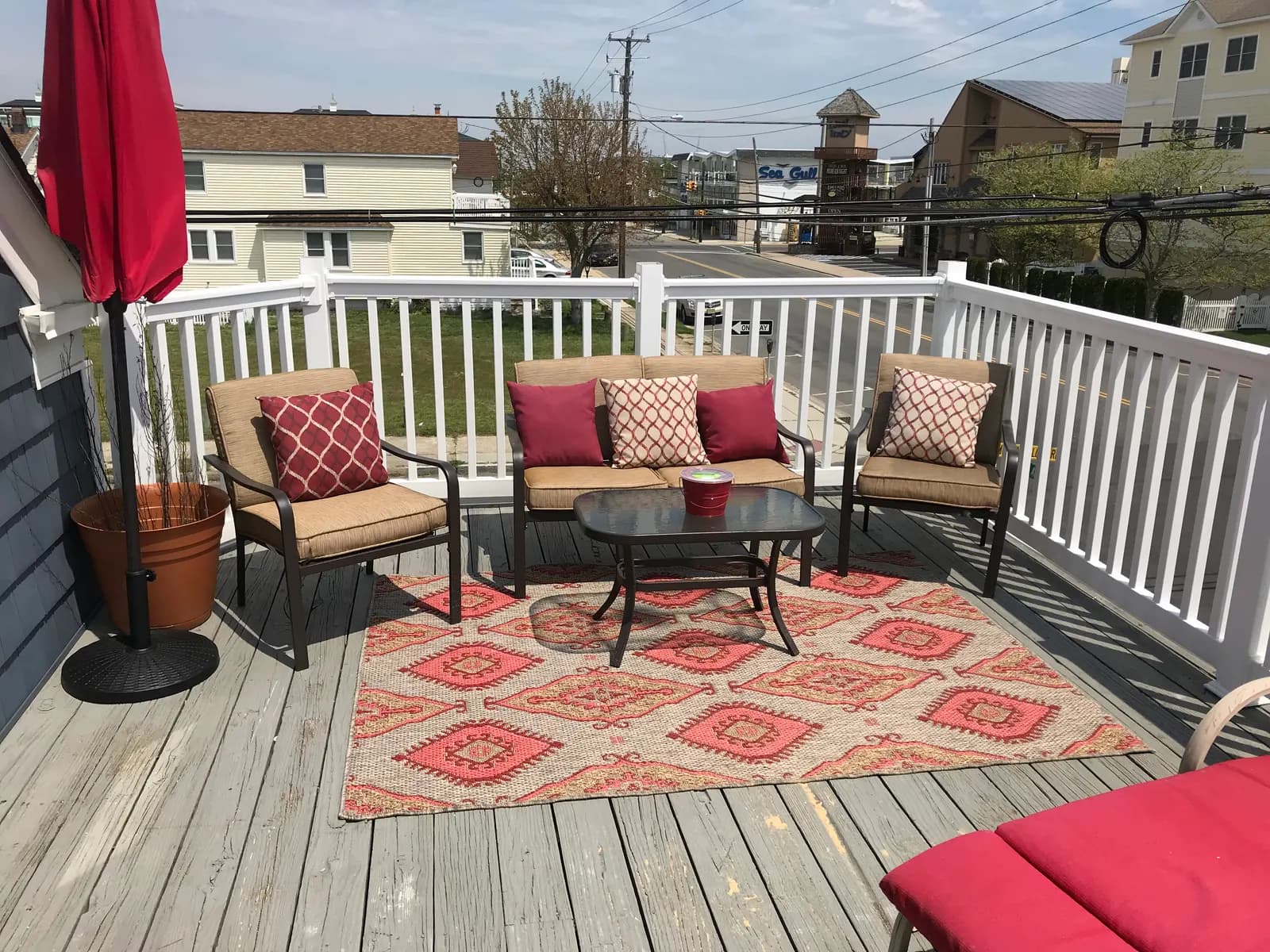Sunny shared deck with red loungers above Wildwood Crest