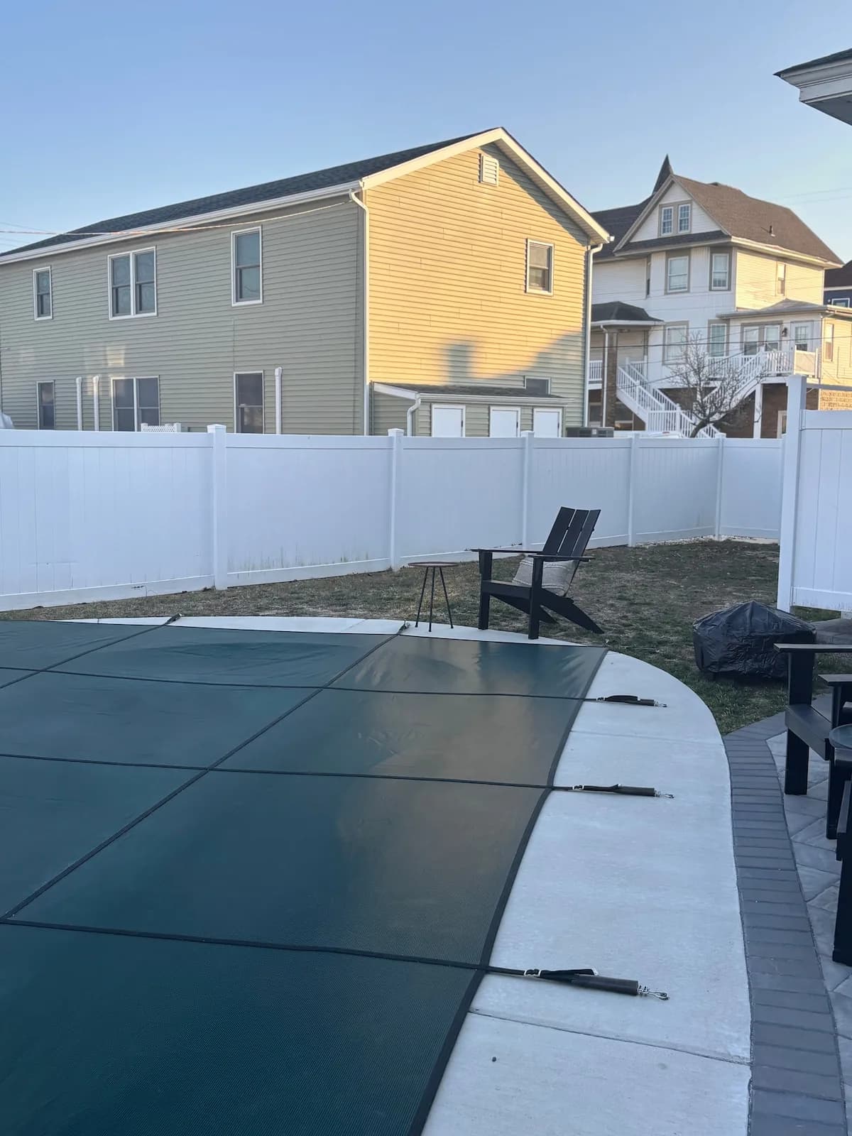 Covered pool and backyard prepared for a day outside