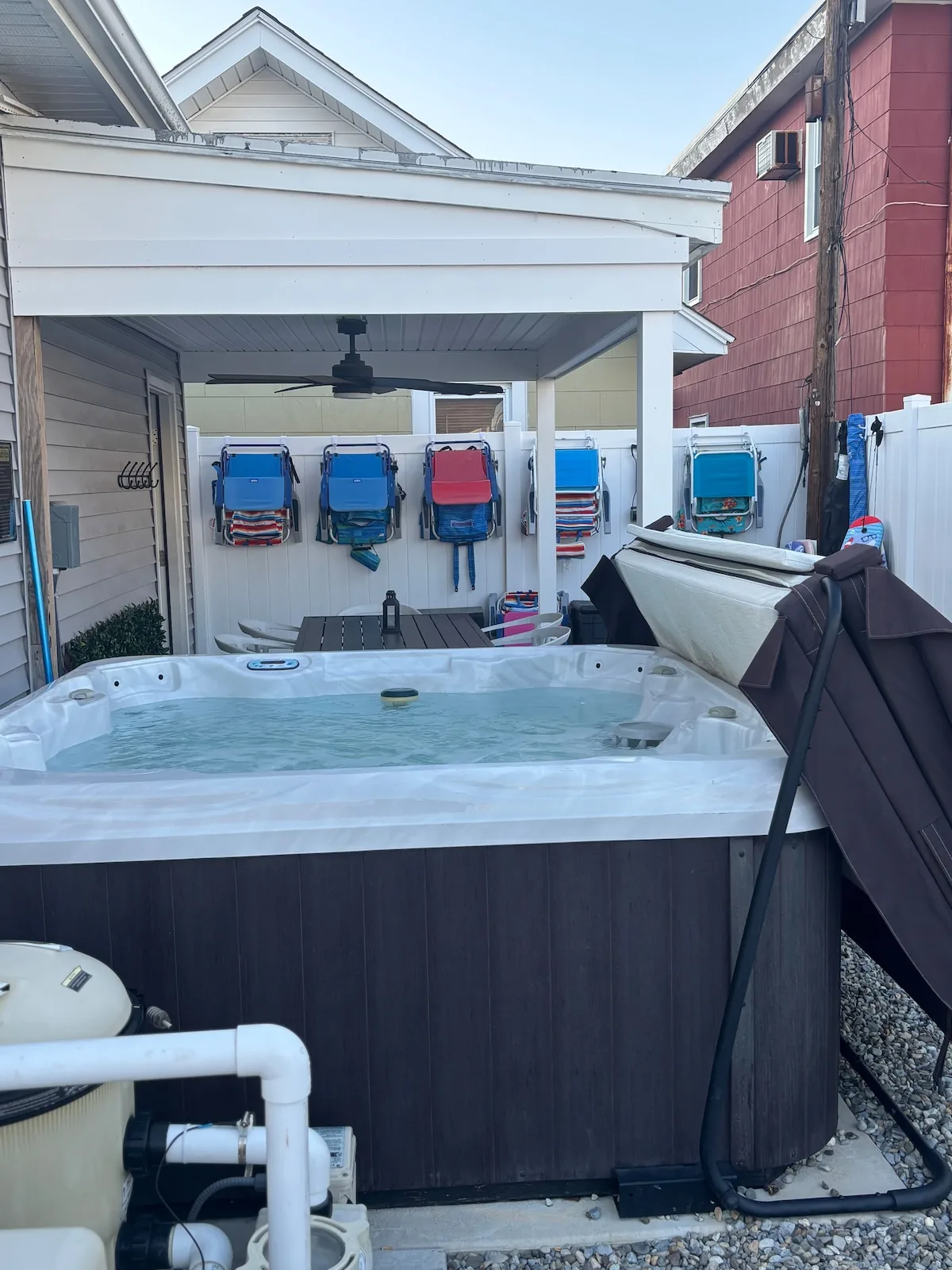 Private hot tub beneath the covered backyard patio