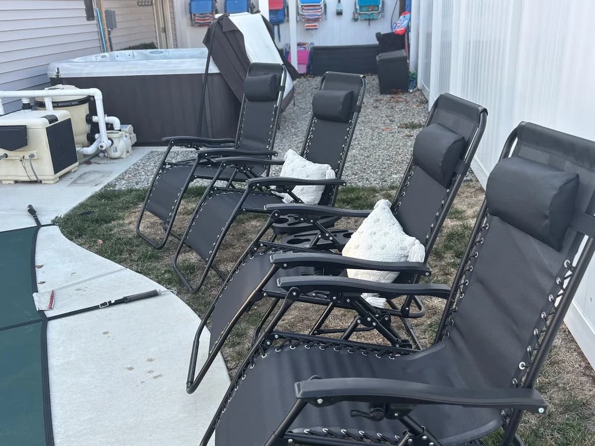 Reclining chairs arranged beside the pool