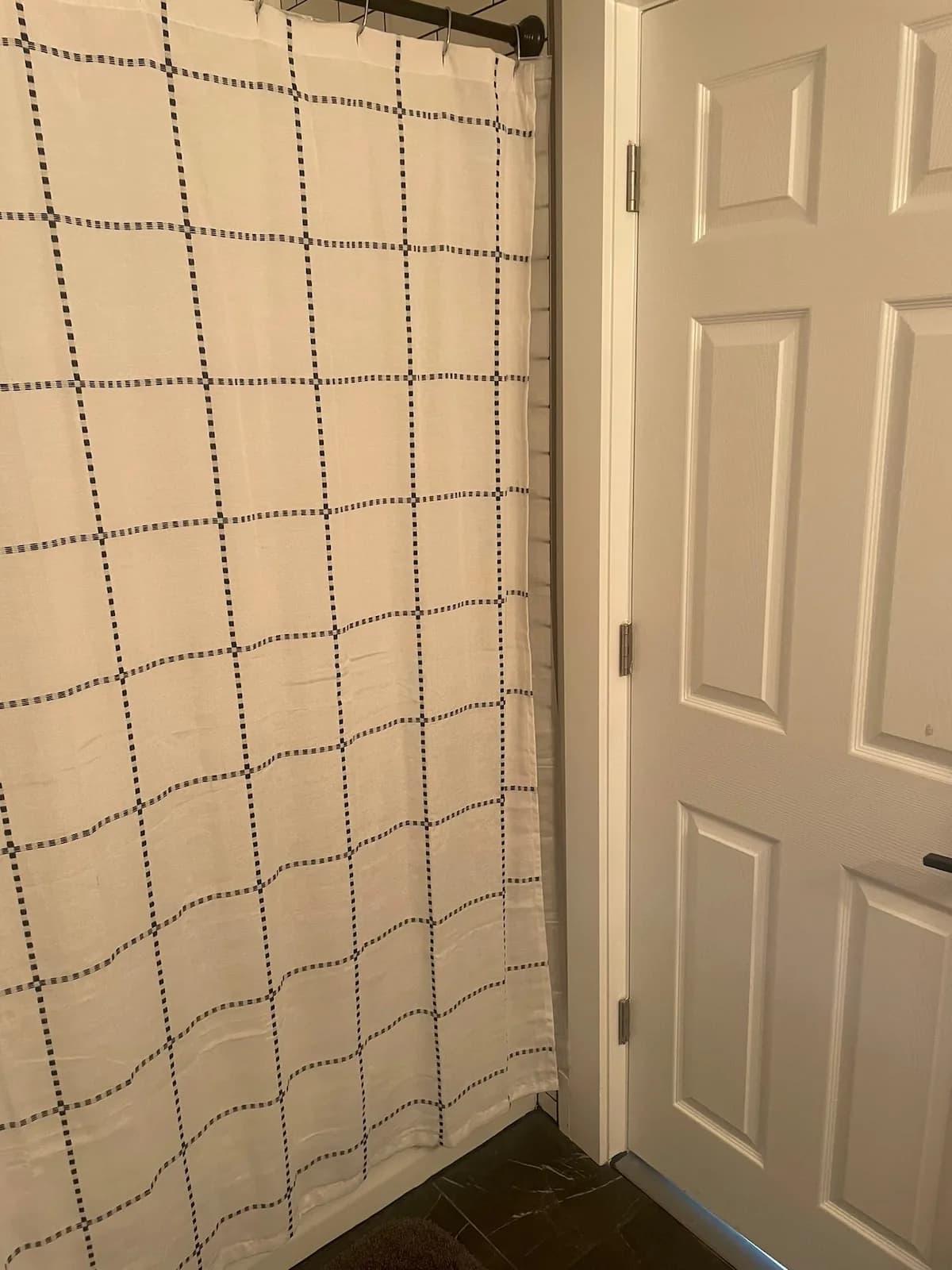 Full bathroom shower with graphic grid curtain