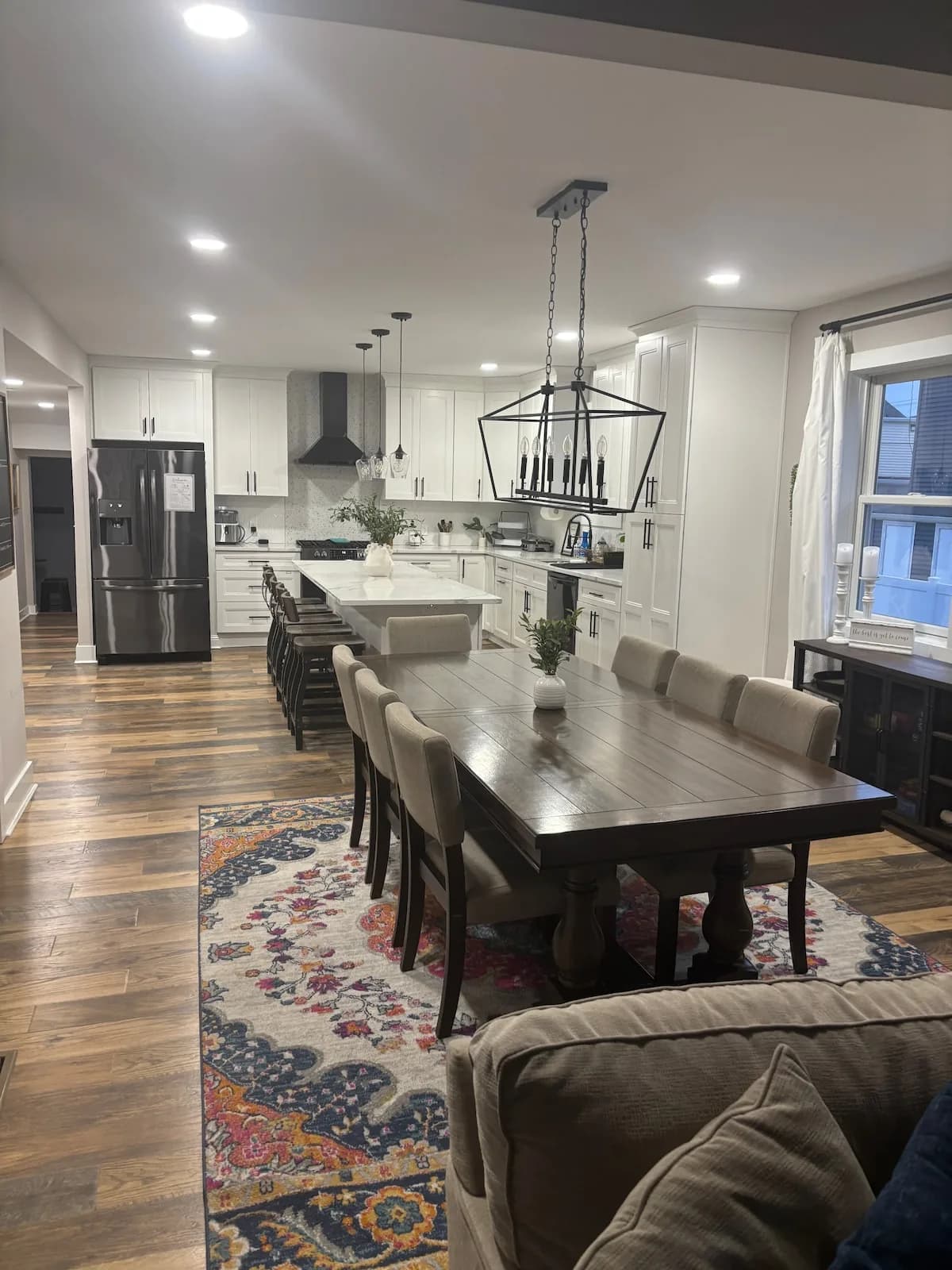 Long dining table beside the open kitchen