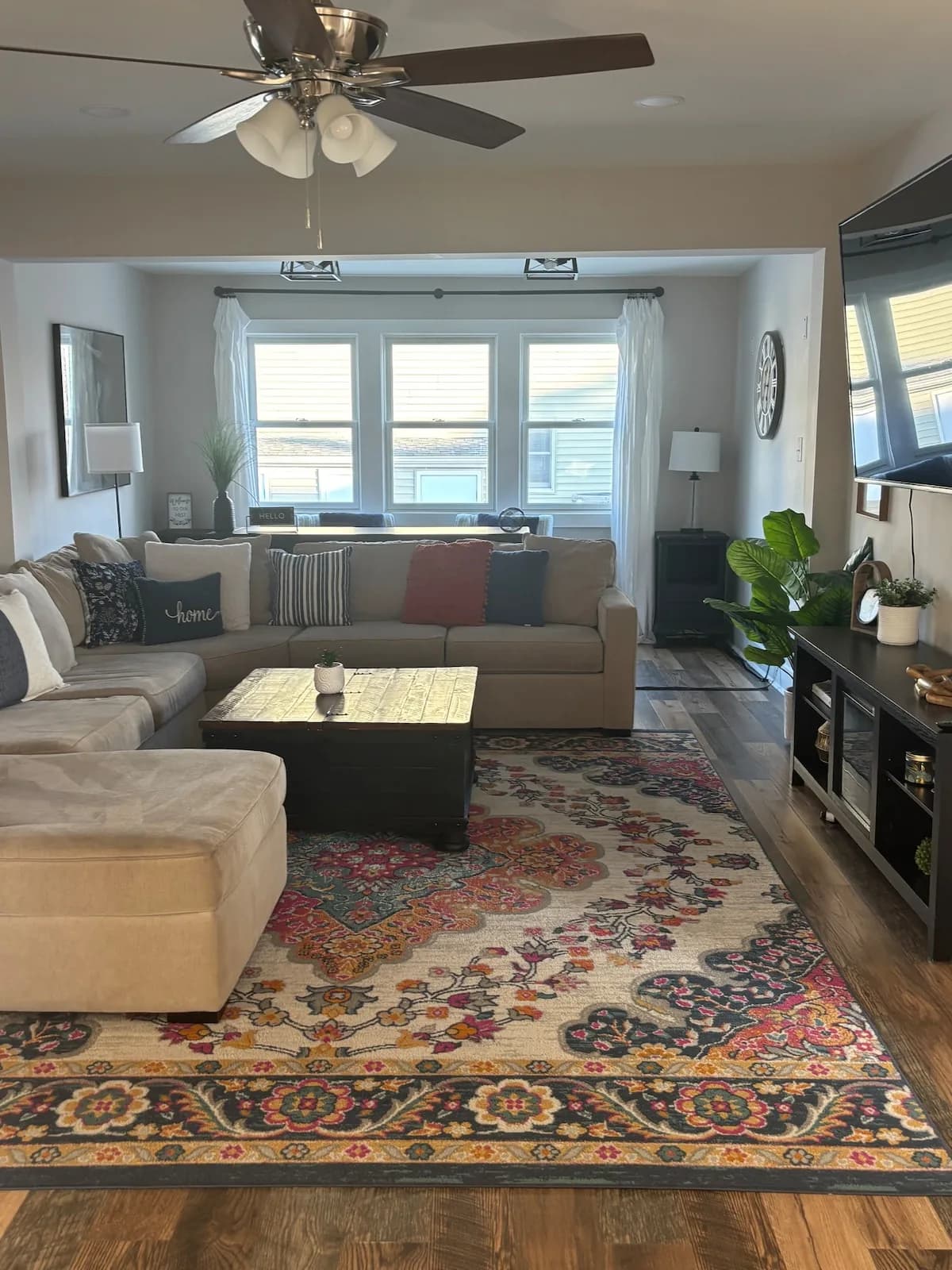 Main living room with layered seating and a colorful rug