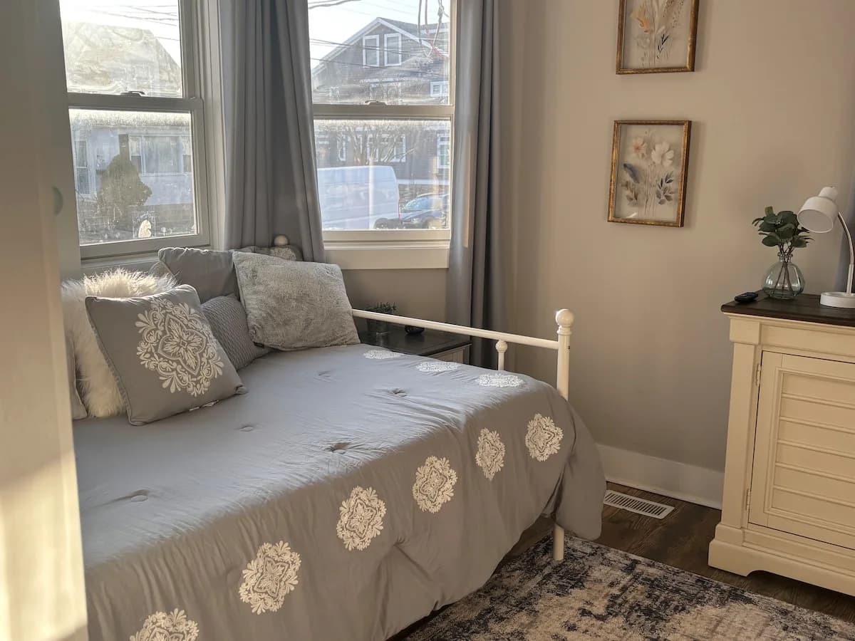 Guest bedroom with a daybed beneath sunlit windows