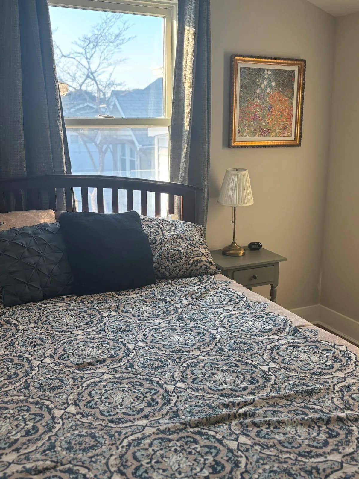 Guest bedroom with a dark wood bed and blue bedding
