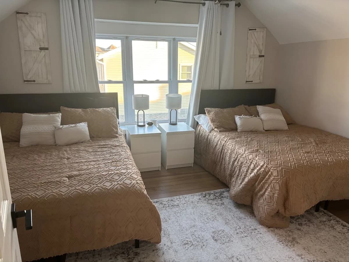 Bedroom with two full beds and balcony doors