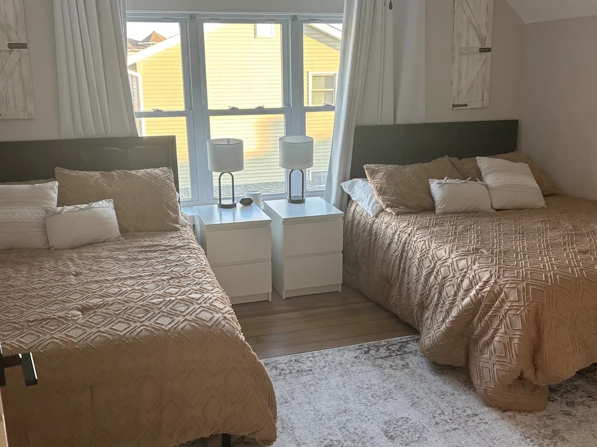 Upstairs bedroom with two beds beneath the eaves