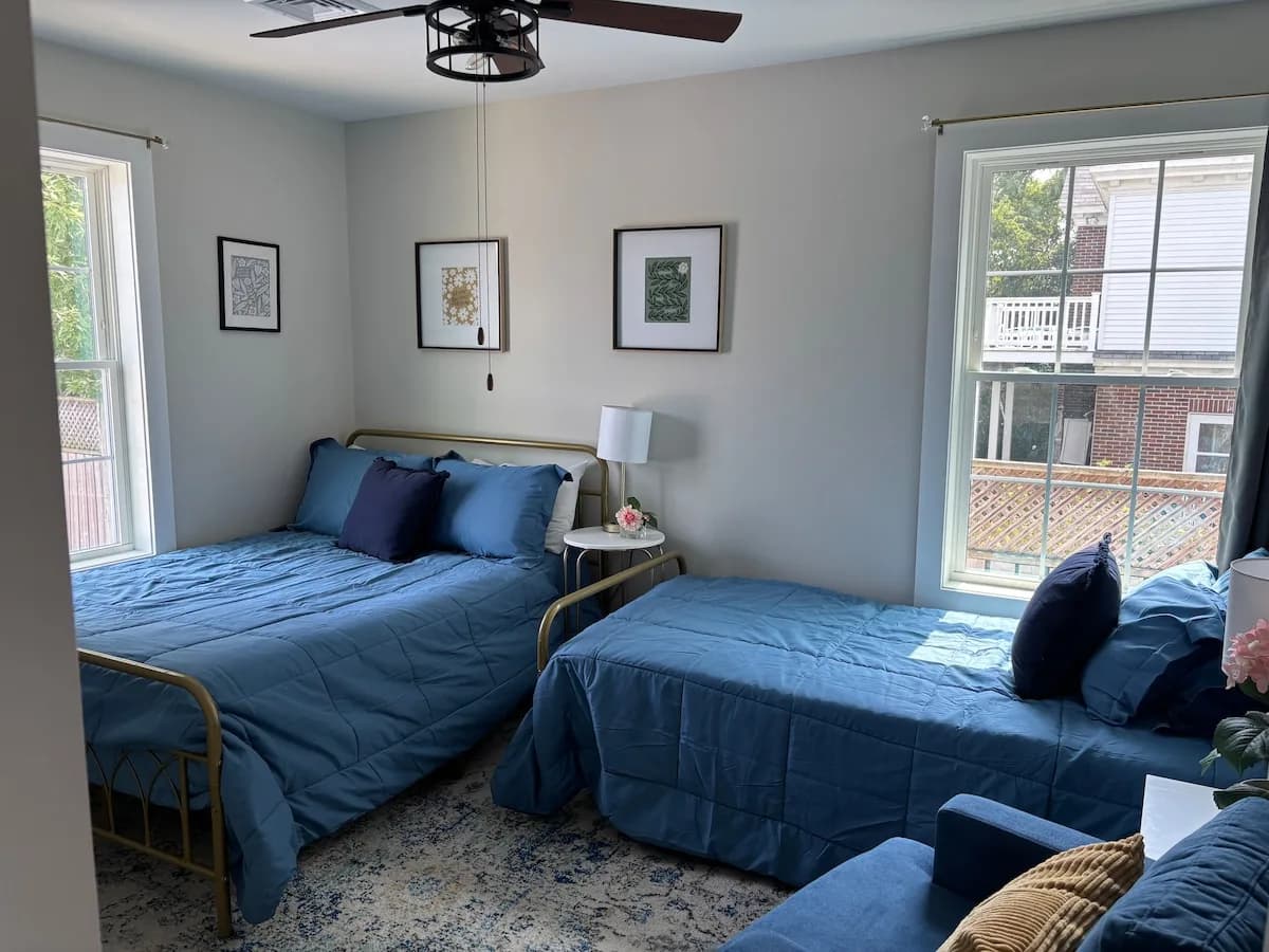 Bright bedroom with two blue beds and room to settle in