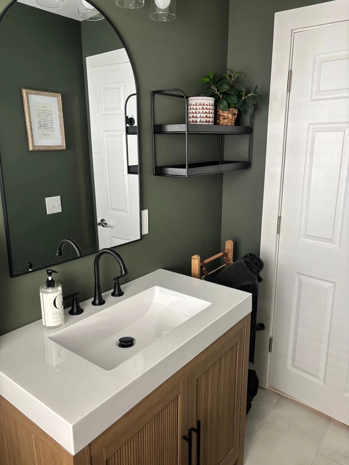 Dark green bathroom with matte-black fixtures