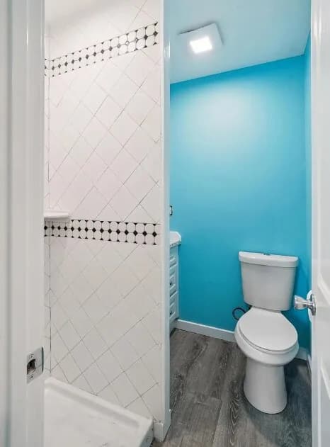 Blue bathroom with tiled shower