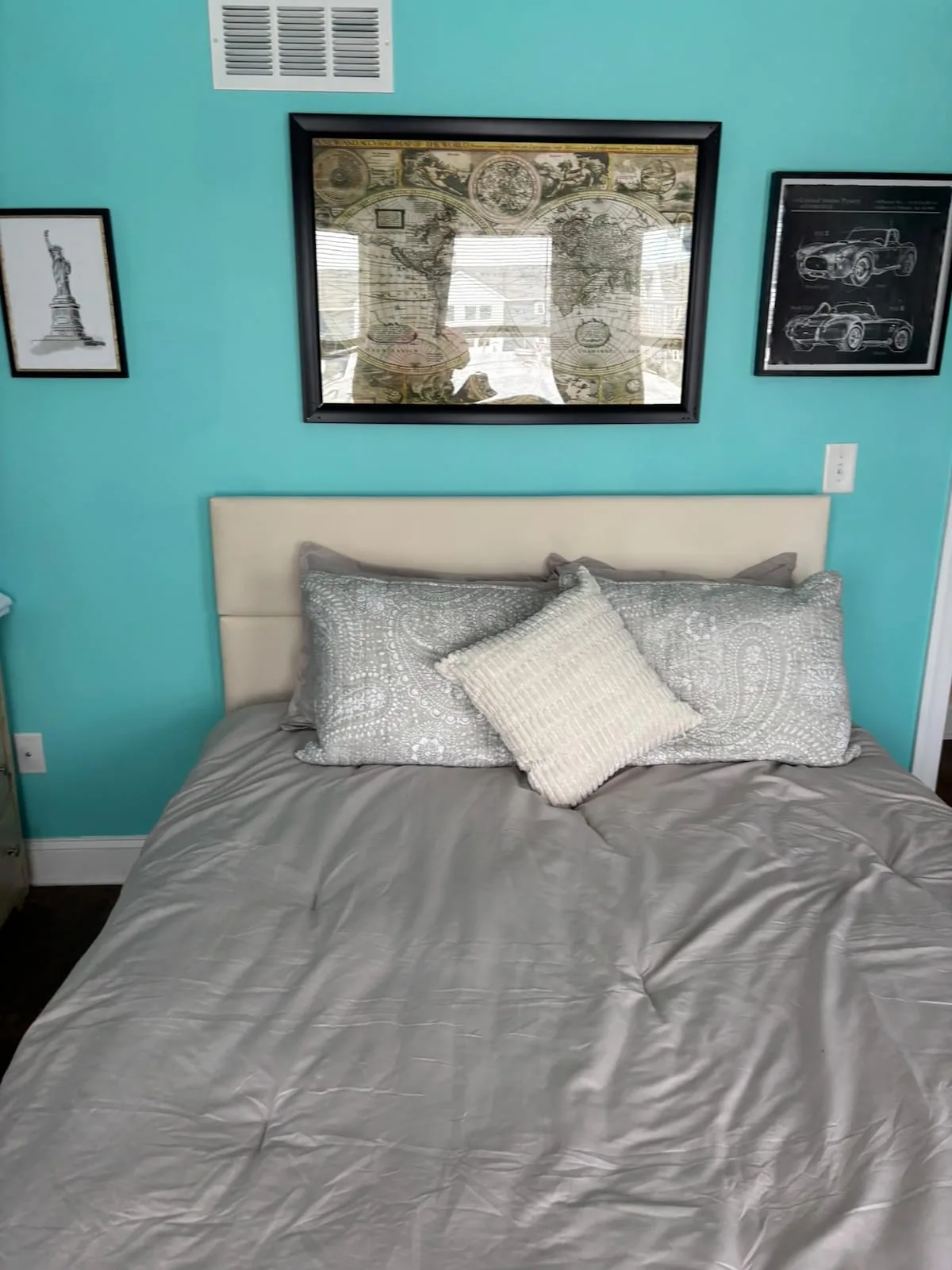 Turquoise bedroom with a soft upholstered bed