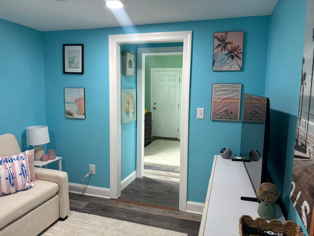 Blue bedroom sitting area connecting to the hall