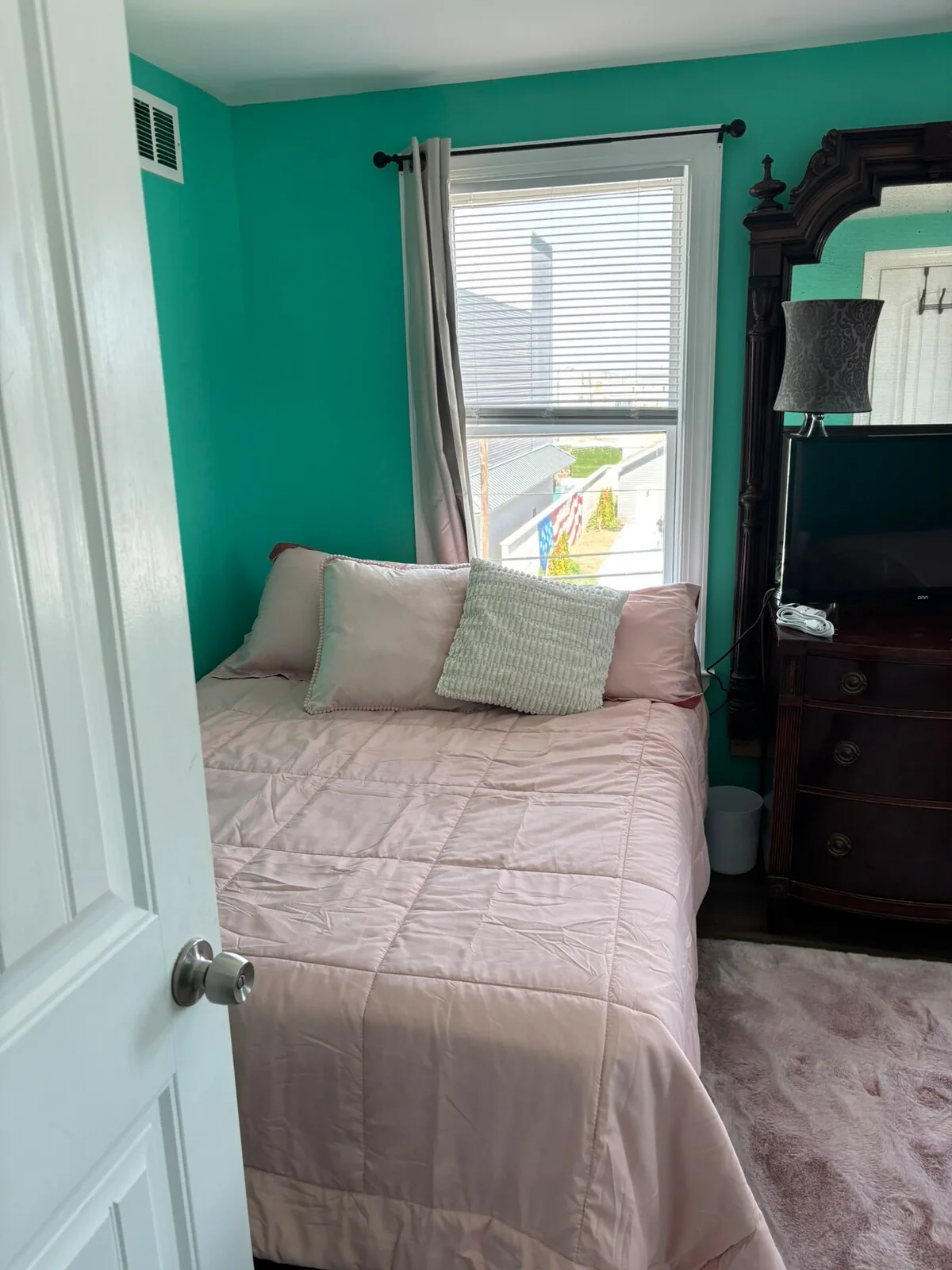 Soft pink guest room with natural light