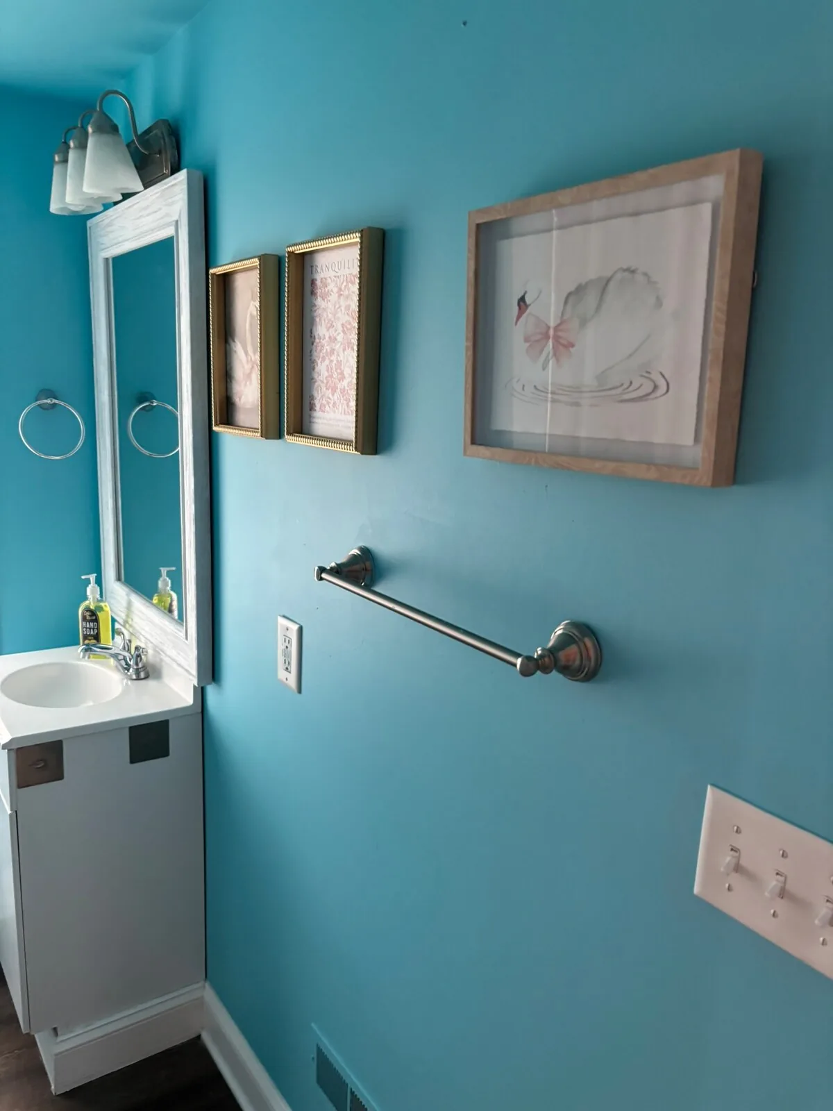 Turquoise bathroom with compact guest conveniences