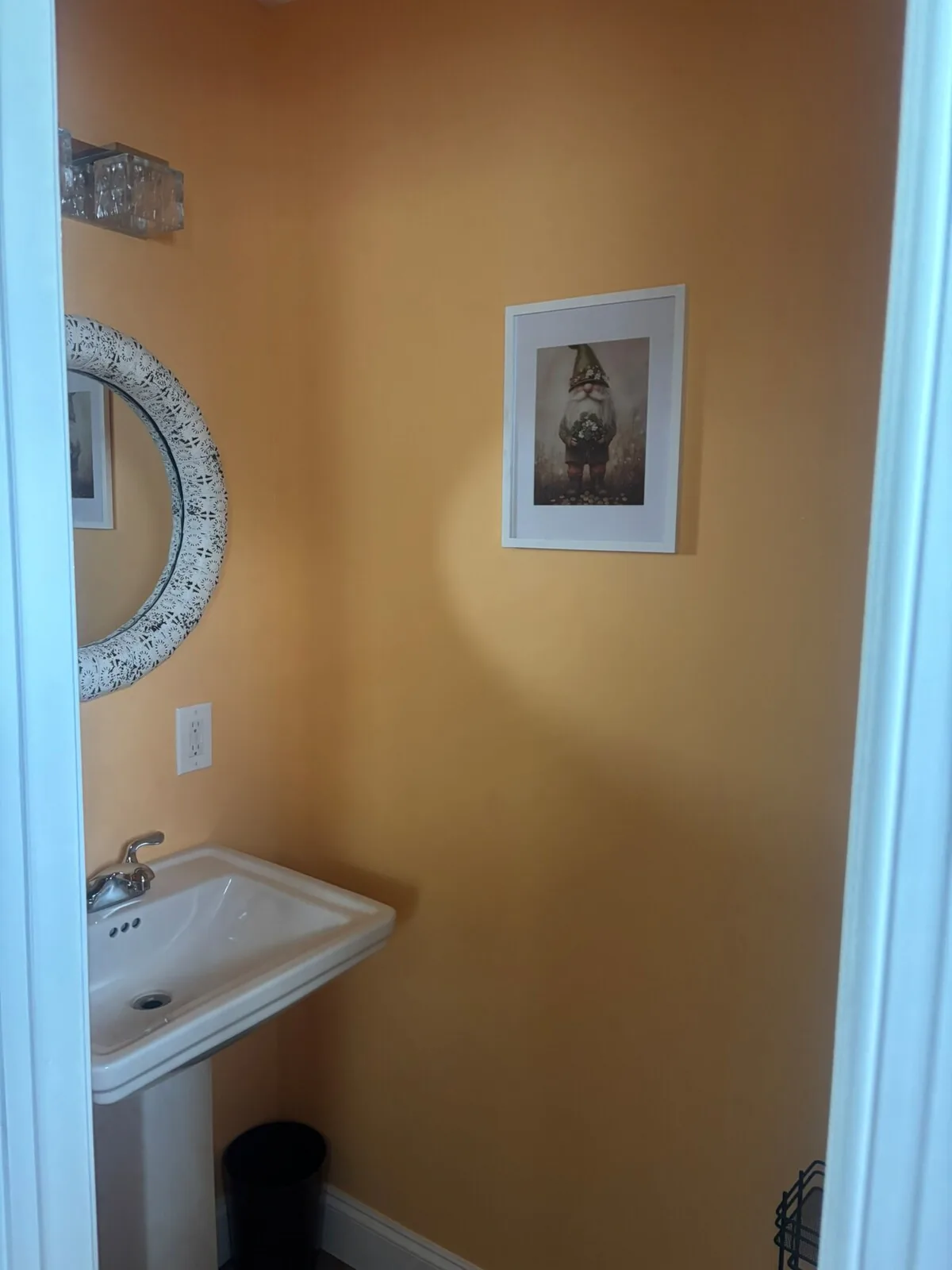 Golden bathroom with round mirror and warm color